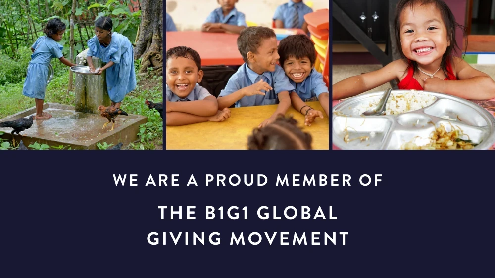 Children in blue uniforms smiling while accessing clean water and sharing meals together outdoors.